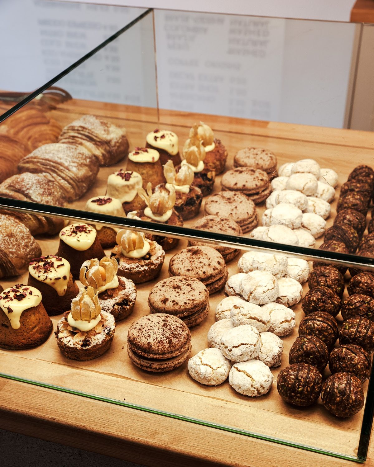 Brew Lab's pastry case with croissants, small cakes, macarons, amaretti-style biscuits and energy balls